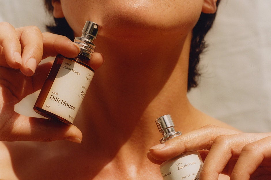 A woman holding a bottle of perfume