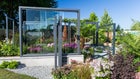 Thumbnail: A glass building with plants and flowers