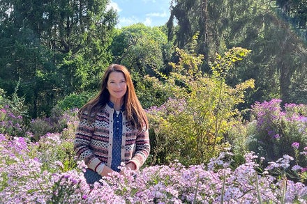 A woman standing in a field of flowers