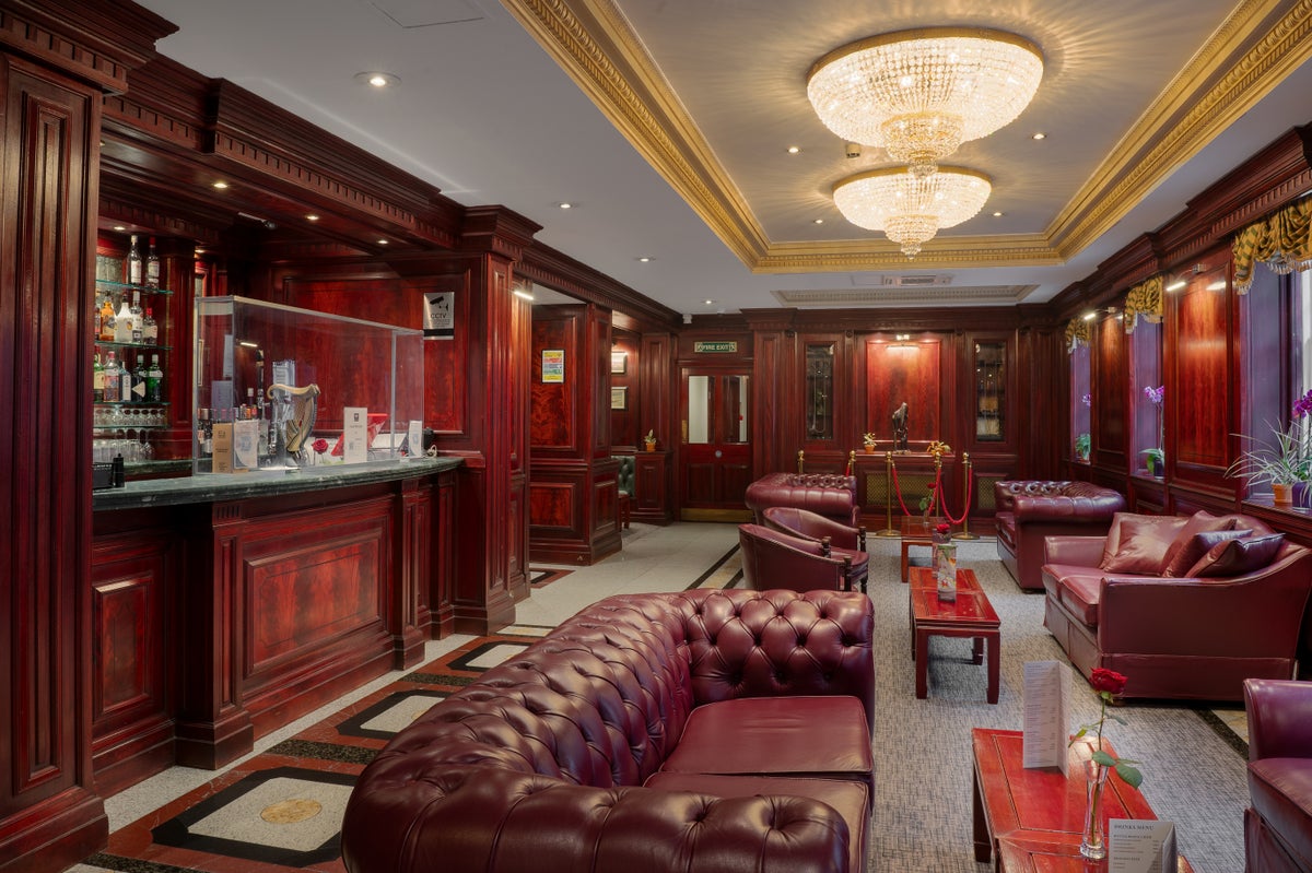 A room with red furniture and a chandelier