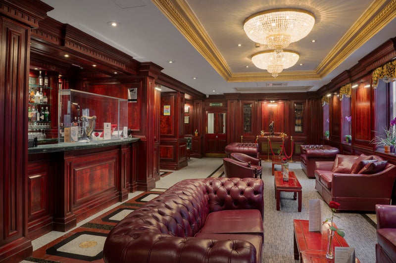A room with red furniture and a chandelier