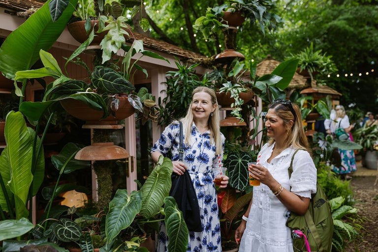 Two women standing in a garden