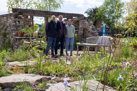 A group of people standing in a garden