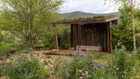 Thumbnail: A wooden structure with a pond and flowers