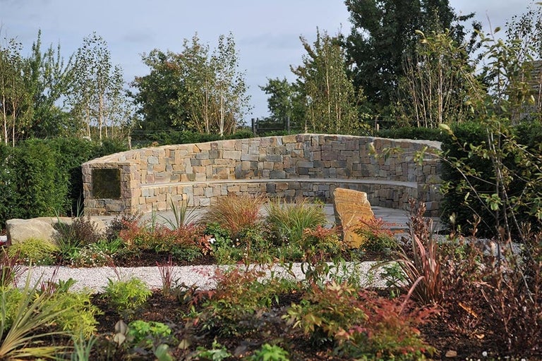 A stone bench in a garden