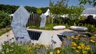 Thumbnail: A garden with a pond and flowers