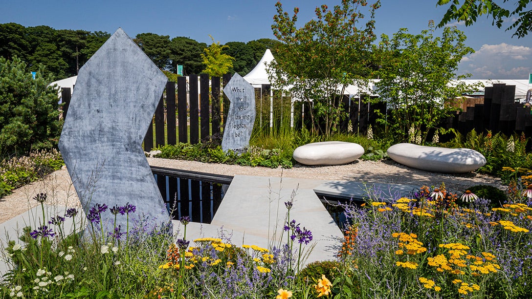 A garden with a pond and flowers