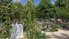 Thumbnail: A garden with a fountain and a table