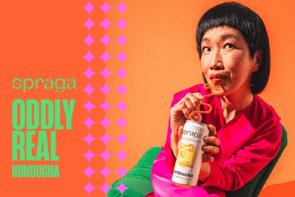 A woman drinking from a can