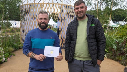 Two men holding a certificate