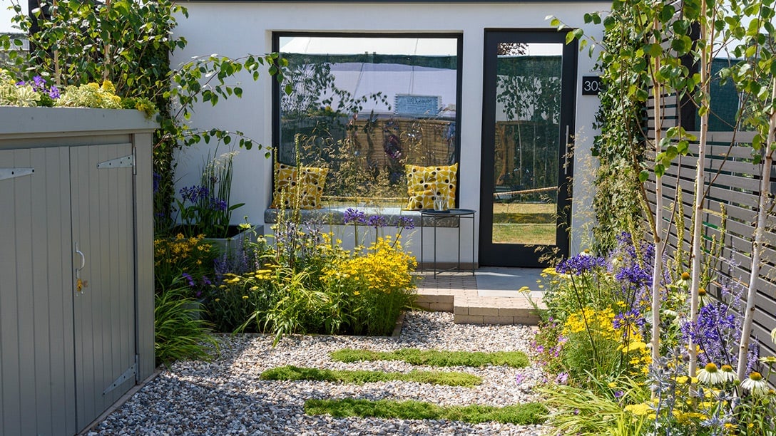 A garden with a bench and plants