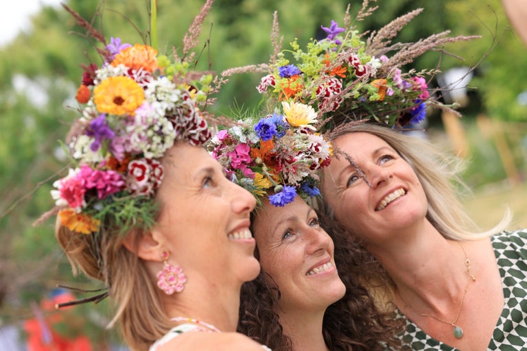 A group of women with flowers on their head