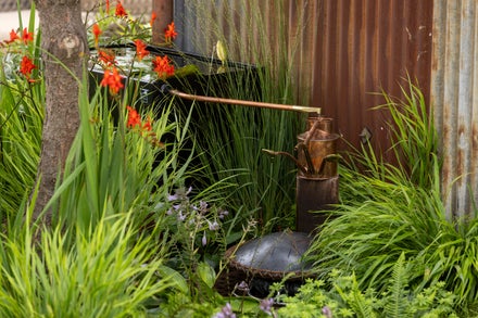 A copper water distiller in a garden