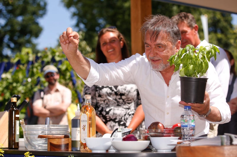 A man holding a pot with a plant in his hand
