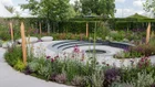 Thumbnail: A garden with a circular walkway and a circular fountain