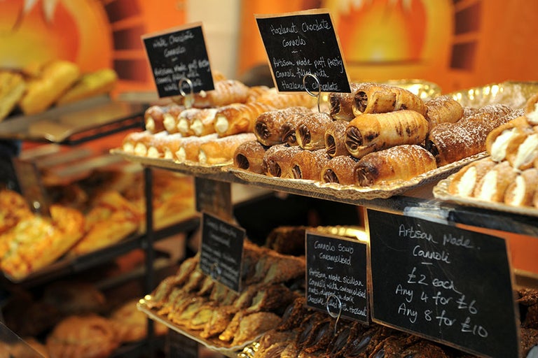 A display of pastries and pastries with signs