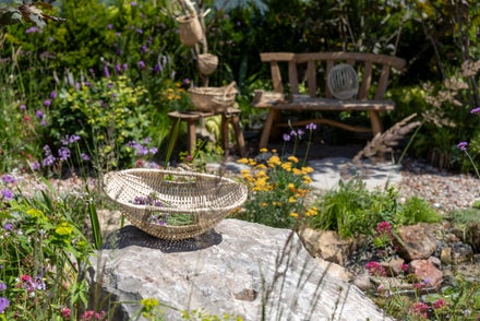 A basket on a rock in a garden