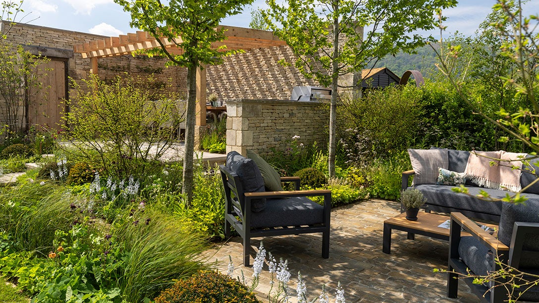 A patio with chairs and trees