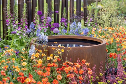 A water feature in a colourful garden