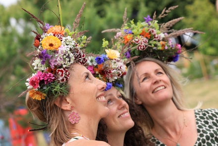 A group of women with flowers on their heads